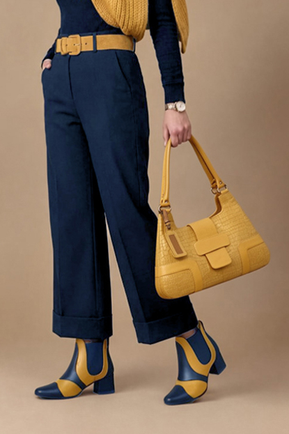 Dress ankle boots side elastics in navy blue and mustard yellow leather with low flare heels and round toe - Worn view